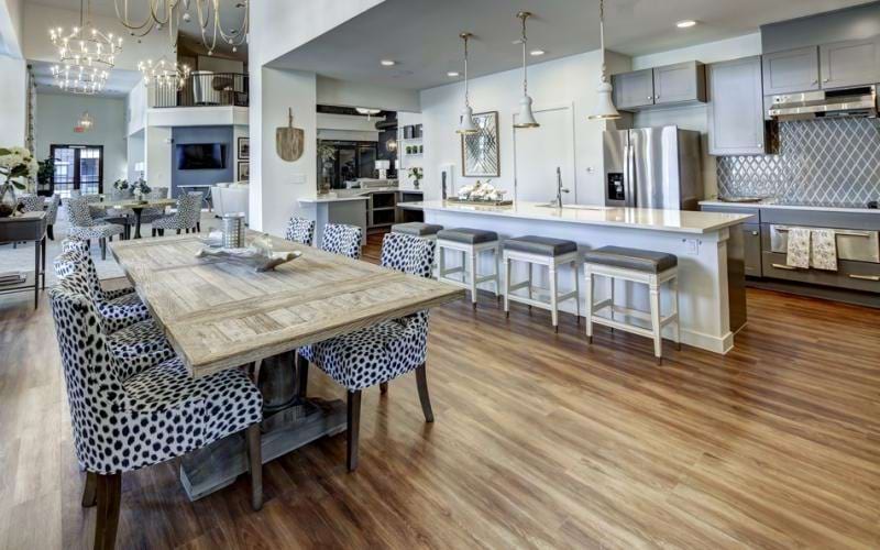 Resident lounge at Northstar Georgetown 55 plus community, featuring wood grain flooring and cushioned chairs.