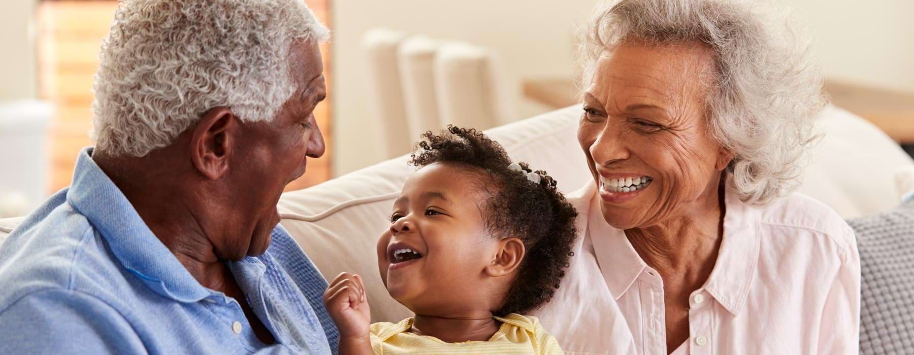 A family sitting on a couch together at Northstar Georgetown 55+ senior living apartments in Georgetown, TX.